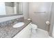 Updated bathroom with granite countertop vanity, modern fixtures, and tiled floor at 7655 Ovaldale Dr, North Charleston, SC 29418