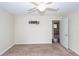 Neutral carpeted bedroom with ceiling fan and doorway view to another room at 7655 Ovaldale Dr, North Charleston, SC 29418