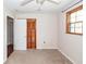 Cozy bedroom features neutral carpeting, natural light from window, and closet with bi-fold doors at 7655 Ovaldale Dr, North Charleston, SC 29418