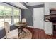 Cozy dining area with a round table, two chairs, and natural light from the adjacent windows at 7655 Ovaldale Dr, North Charleston, SC 29418