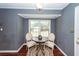 Bright dining area featuring a wooden table and two chairs set near a window for natural light at 7655 Ovaldale Dr, North Charleston, SC 29418