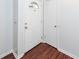 Bright entryway featuring wood-look flooring, a white front door, and a coat closet for storage at 7655 Ovaldale Dr, North Charleston, SC 29418