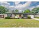Attractive brick home with blue shutters, well-maintained lawn, and inviting curb appeal at 7655 Ovaldale Dr, North Charleston, SC 29418