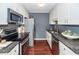Modern kitchen with stainless steel appliances, granite countertops, and ample cabinet space at 7655 Ovaldale Dr, North Charleston, SC 29418