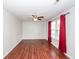 Spacious living room featuring wood-look floors, bright windows, and a modern ceiling fan at 7655 Ovaldale Dr, North Charleston, SC 29418