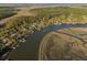Stunning aerial view of waterfront homes with docks, showcasing the serene river and beautiful surrounding landscape at 7897 Russell Creek Dr, Edisto Island, SC 29438