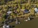 Aerial view of waterfront homes with private docks on the river, surrounded by greenery and trees at 7897 Russell Creek Dr, Edisto Island, SC 29438