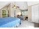 Bright bedroom featuring vaulted ceilings, balcony access, and a comfortable seating area at 7897 Russell Creek Dr, Edisto Island, SC 29438