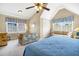Bright bedroom featuring vaulted ceilings, plantation shutters, and a comfortable seating area at 7897 Russell Creek Dr, Edisto Island, SC 29438