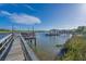 Views of the river with boat houses and walkway for easy access to the waterway at 7897 Russell Creek Dr, Edisto Island, SC 29438