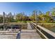 Scenic view of a wooden dock leading to a charming home nestled among lush greenery, evoking tranquility at 7897 Russell Creek Dr, Edisto Island, SC 29438
