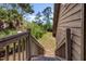 Exterior shot looking up the steps of this charming home surrounded by lush greenery at 7897 Russell Creek Dr, Edisto Island, SC 29438