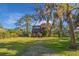 Charming two-story home with a well-manicured lawn and lush landscaping at 7897 Russell Creek Dr, Edisto Island, SC 29438
