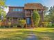 Charming two-story home with a well-manicured lawn and lush landscaping at 7897 Russell Creek Dr, Edisto Island, SC 29438