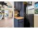 Kitchenette with dark cabinets, stainless appliances, and seamless flow to living areas create inviting functional space at 7897 Russell Creek Dr, Edisto Island, SC 29438