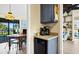 A cozy kitchenette features a coffee station, modern appliances, and a charming view of the dining area at 7897 Russell Creek Dr, Edisto Island, SC 29438