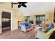 Bright and airy living room with comfortable seating, wood floors, and sliding door access to screened in patio at 7897 Russell Creek Dr, Edisto Island, SC 29438