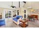 Living room with comfortable seating and a dining area, offering bright space with wood floors and access to outdoor living at 7897 Russell Creek Dr, Edisto Island, SC 29438