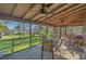 Spacious screened porch with outdoor dining and seating area overlooking the waterfront at 7897 Russell Creek Dr, Edisto Island, SC 29438