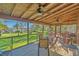 Spacious screened porch with a vaulted ceiling, ceiling fans, and scenic waterfront views at 7897 Russell Creek Dr, Edisto Island, SC 29438