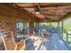 Inviting screened porch featuring wood ceiling, ceiling fans and plenty of room for dining and relaxing at 7897 Russell Creek Dr, Edisto Island, SC 29438