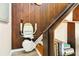 Stair lift installed alongside wooden stairs with convenient access to books and an accessible design at 7897 Russell Creek Dr, Edisto Island, SC 29438