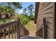 Wooden staircase offering a glimpse of the lush backyard and serene surroundings of the property at 7897 Russell Creek Dr, Edisto Island, SC 29438