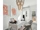 A cozy home office featuring an elegant chandelier, white desk, and view to the outdoors at 5577 Ruby Falls Dr, North Charleston, SC 29420