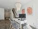 Inviting home office features decorative chandelier, white desk, and access to the staircase at 5577 Ruby Falls Dr, North Charleston, SC 29420