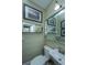 Half bath with vintage wallpaper and a framed picture of a rowing team adds a classic touch at 9 Bogard St # 3, Charleston, SC 29403