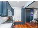 Well-appointed kitchen boasts stainless steel appliances, blue cabinetry, and hardwood floors at 9 Bogard St # 3, Charleston, SC 29403