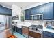 Modern kitchen featuring stainless steel appliances, farmhouse sink, and white subway tile backsplash at 9 Bogard St # 3, Charleston, SC 29403