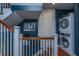 Convenient laundry area with stacked washer and dryer next to stairs and hardwood floors at 9 Bogard St # 3, Charleston, SC 29403