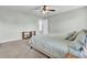 A primary bedroom featuring a ceiling fan, light green walls, and neutral carpet at 9676 Godwin St, Ladson, SC 29456