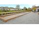 Bocce Ball Court surrounded by sidewalks, a landscaped greenway, and residential neighborhood homes at 9676 Godwin St, Ladson, SC 29456