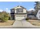 Charming two-story home with a well-manicured lawn and attached garage at 9676 Godwin St, Ladson, SC 29456