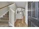 Inviting foyer with hardwood floors, staircase, and open view to other rooms enhance this home's appeal at 9676 Godwin St, Ladson, SC 29456