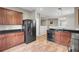 Well-equipped kitchen with wood cabinets, black appliances, and laminate floors enhance this home's appeal at 9676 Godwin St, Ladson, SC 29456