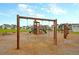 Swingset at the community playground area with houses in the background at 9676 Godwin St, Ladson, SC 29456