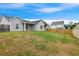 A backyard is perfect for recreation with a well-maintained lawn, home, and fence at 1007 Halfacre Ln, Ladson, SC 29456
