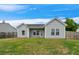 A well-maintained backyard features a lush green lawn with the exterior of the home at 1007 Halfacre Ln, Ladson, SC 29456