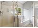 A bright bathroom featuring a shower, soaking tub, and window at 1007 Halfacre Ln, Ladson, SC 29456