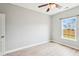 This bedroom features light, airy walls, a ceiling fan, and a window with a view at 1007 Halfacre Ln, Ladson, SC 29456
