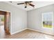 Bright bedroom with wood floors, ceiling fan and a sunny window showcasing the lovely lawn at 1007 Halfacre Ln, Ladson, SC 29456