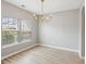 A bright dining room with hardwood floors, two windows, and a modern chandelier at 1007 Halfacre Ln, Ladson, SC 29456