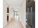 Hallway with views of the kitchen and other rooms, all featuring neutral paint and wood flooring at 1007 Halfacre Ln, Ladson, SC 29456