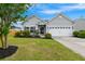 Charming single-story home with a well-maintained lawn, manicured landscaping, and an attached two-car garage at 1007 Halfacre Ln, Ladson, SC 29456