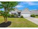 Attractive single-story home with a manicured lawn, beautiful landscaping, and an attached two-car garage at 1007 Halfacre Ln, Ladson, SC 29456