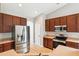 Well-equipped kitchen featuring stainless steel appliances, wood cabinets, and a breakfast bar at 1007 Halfacre Ln, Ladson, SC 29456