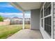 A covered patio shows serene outdoor living with view of the grassy, fenced backyard at 1007 Halfacre Ln, Ladson, SC 29456